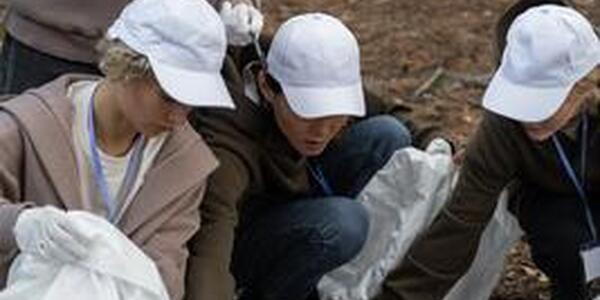 four women volunteering in woods