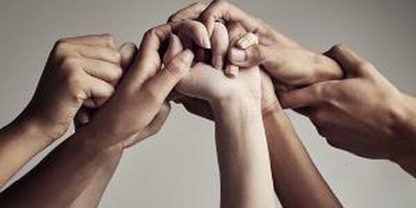diverse hands reaching out supporting each other