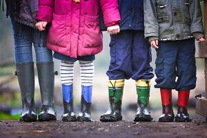 children wearing rainboots