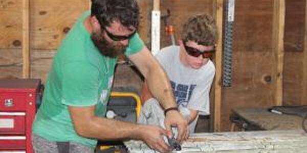 boy and dad learning to solder 