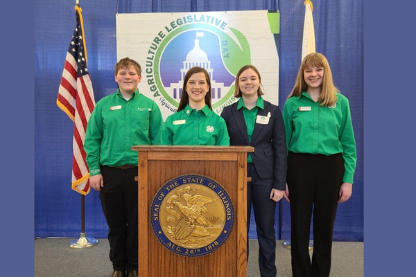 youth reps pose by a podium at the event