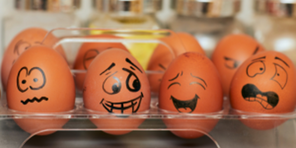 Brown eggs with different faces drawn on them representing various emotions.