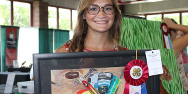 girl holding painting she made