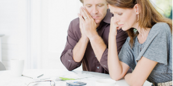 man and woman staring at bills