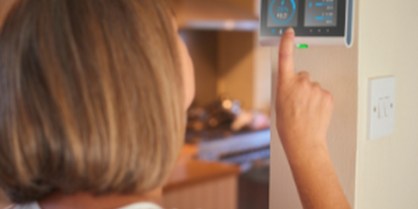 Woman changing thermostat