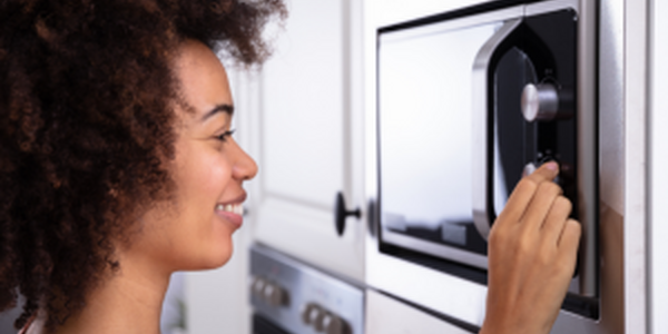 woman using microwave