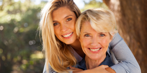 Young woman hugging older woman