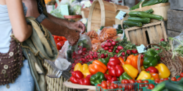 Barrels of veggies at a farmer's market